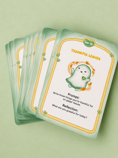 A fanned stack of mint green and cream reflective card decks titled 'THANKFUL LEAVES' on a matching pale green background. The top card features a cute ghost-like leaf illustration and prompts for gratitude and reflection.