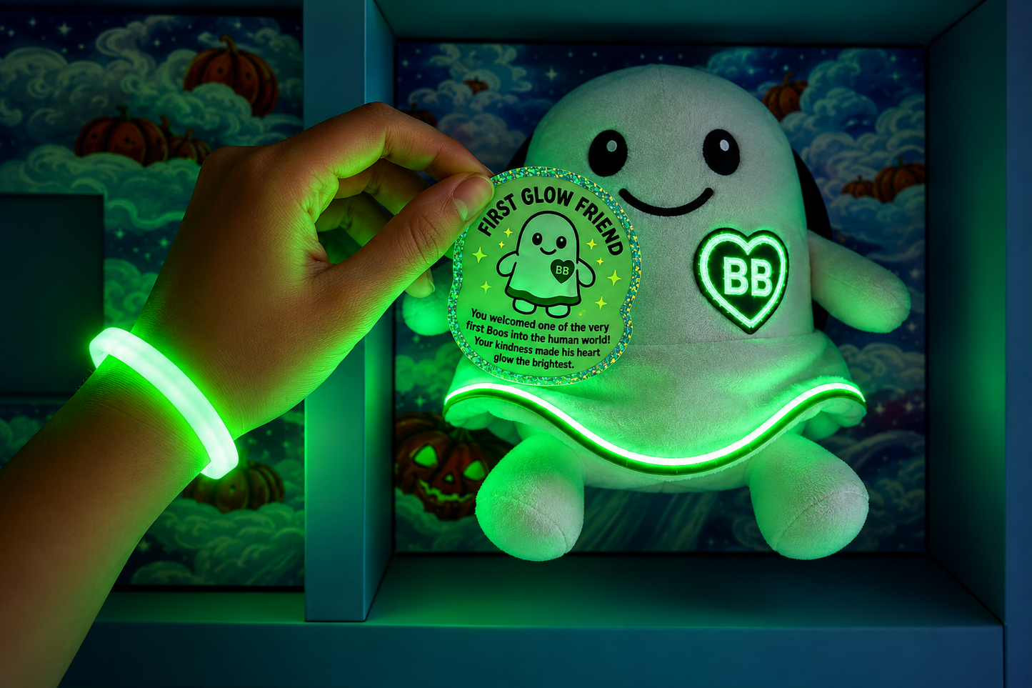 A glowing green plush ghost toy sits on a shelf, with a hand holding a matching circular glow sticker that reads 'First Glow Friend.' The hand also wears a glowing green wristband.