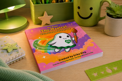 A children's coloring book titled 'The Magical Coloring Adventure' by Erika King, featuring a cute white cartoon character with a green shield and paintbrush, styled on a wooden desk with a green lamp, smiley face mug, and small plant.
